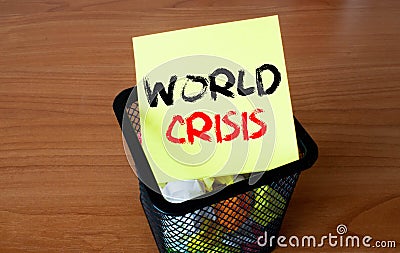 WORLD CRISIS inscription on a piece of paper in a trash can Stock Photo