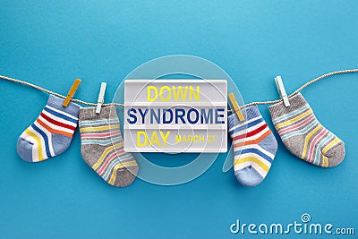 World Down syndrome day background. Down syndrome awareness concept. Socks and lightbox on blue background Stock Photo