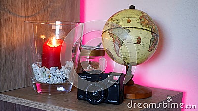 World earth globe in a decorated room with LED back lighting and candle light. Stock Photo