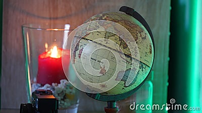 World earth globe in a decorated room with LED back lighting and candle light. Stock Photo