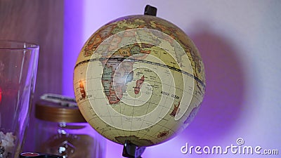 World earth globe in a decorated room with LED back lighting and candle light. Stock Photo