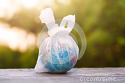 World environment day, earth globe wrapped in transparent plastic bag Stock Photo