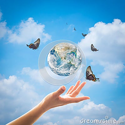 World environment day, ecology and ozone layer protection concept with woman`s hand supporting earth planet under sun light flare Stock Photo