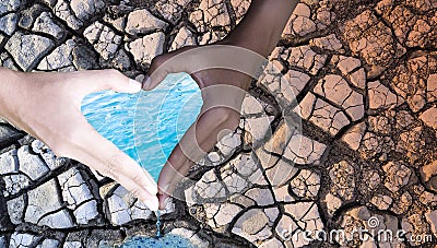 Environment Day.People hold hands in heart shape, with water and dry soil on the background. Water conservation concept Stock Photo