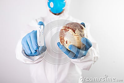 Doctor holding the planet Earth and coronavirus test Stock Photo