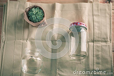 World free of plastic.Green products - bag made from bamboo or reuse, succulent and glass jar on nature wood background. Stock Photo