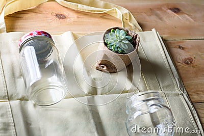 World free of plastic.Green products-bag made from bamboo or reuse, succulent and glass jar on nature wood background. Stock Photo