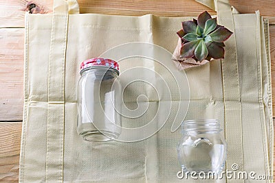 World free of plastic.Green products-bag made from bamboo or reuse, succulent and glass jar on nature wood background. Stock Photo