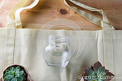 World free of plastic.Green products-bag made from bamboo or reuse, succulent and glass jar on nature wood background. Stock Photo