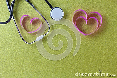 World health day background of Stethoscope with pink ribbon heart on beautiful colorful paper background,Healthcare and medical Stock Photo