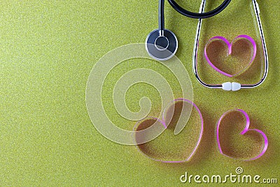 World health day background of Stethoscope with pink ribbon heart on beautiful colorful paper background,Healthcare and medical Stock Photo