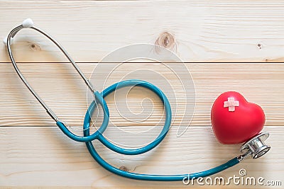 World health day campaign with red heart with cross bandage band-aid and medical doctor`s stethoscope, Cholesterol test Stock Photo