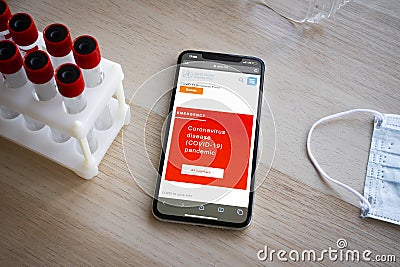World Health Organization page on phone screen top view. Covid-19 or Coronavirus info on Who.int website, red warning screen of Editorial Stock Photo