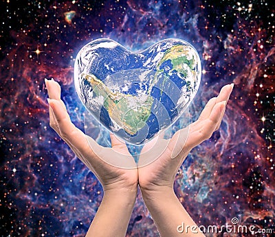 World in heart shape with over women human hands Stock Photo