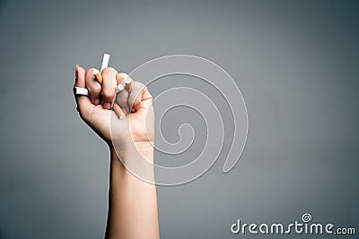 World No Tobacco Day, May 31. STOP Smoking. Close up Man hand crushing and destroying cigarettes on gray background Stock Photo