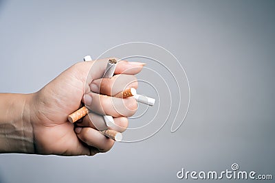 World No Tobacco Day, May 31. STOP Smoking. Close up Man hand crushing and destroying cigarettes on gray background Stock Photo