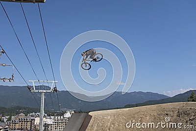 A bike rider at Crankworx Whistler 2022 practices his jumps Editorial Stock Photo