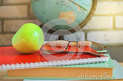 World teacher's Day at school. Still life with books, globe, Apple, glasses, sunlight Stock Photo