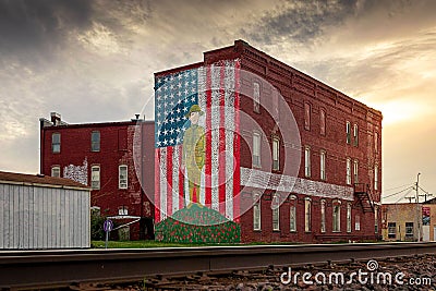 World War I doughboy and US flag painted on this side of a historical building in Holden Editorial Stock Photo