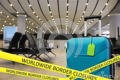 Worldwide border closures through quarantine during coronavirus. Suitcase in airport and yellow awareness ribbons Stock Photo