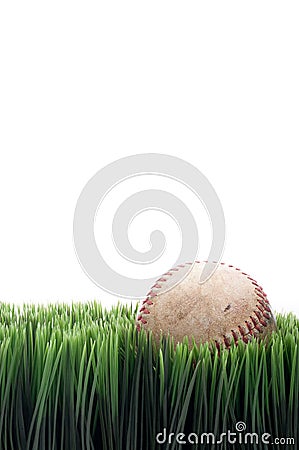 A worn leather baseball in grass Stock Photo