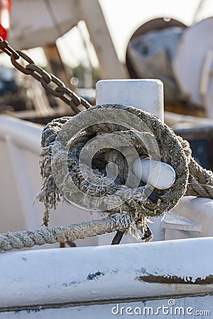 Worn line securing commercial fishing boat to dock Stock Photo