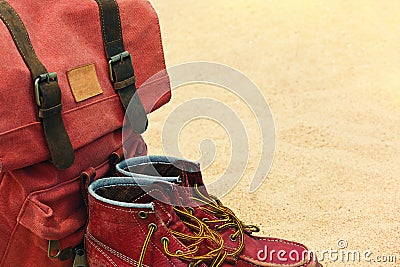 Worn old boots and retro rucksack on a beach Stock Photo