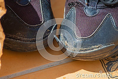 Worn-out shoe showing the growth of inflation and the aggravation of the economic situation, in which residents have to refuse to Stock Photo