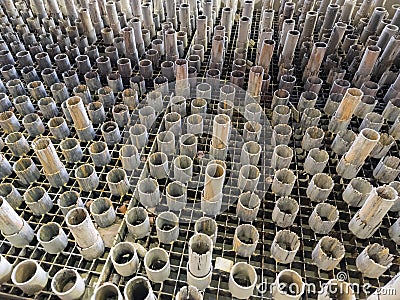 worn out supporting pipes in drained waterjet machine pool during replacement Stock Photo