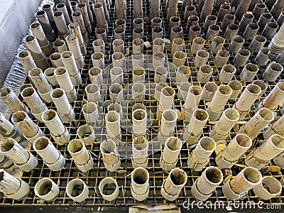 worn out supporting pipes in drained waterjet machine pool during replacement Stock Photo