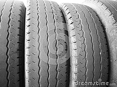 worn tyres stacked side by side sidelit Stock Photo