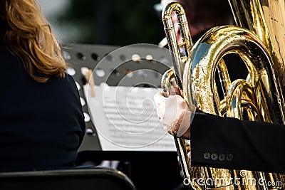 Worn wind instrument. Detail of a musician playing the tuba in a classical concert Stock Photo