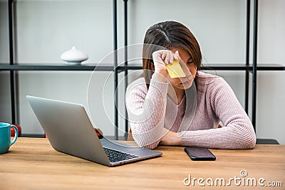 Worried Asian woman having problem with blocked credit card Editorial Stock Photo