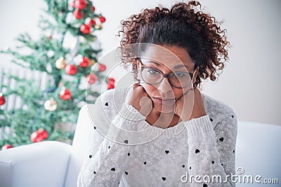 Worried black young woman at home on christmas holiday Stock Photo