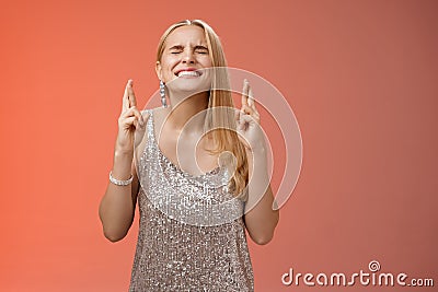 Worried blond woman put effort god hear prayers intense close eyes clench teeth raise head up praying supplicating cross Stock Photo