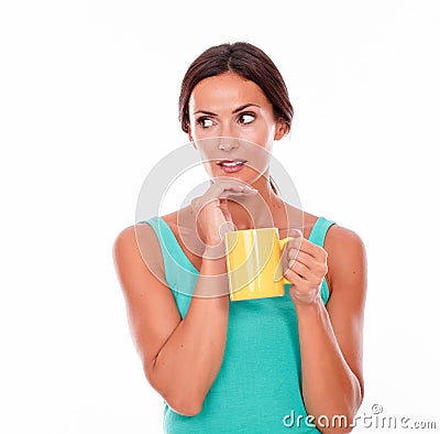 Worried brunette woman with coffee mug Stock Photo