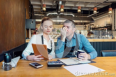 Worried business owners calculating finances - Small restaurant entrepreneurs SME go bankrupt due to Coronavirus pandemic Stock Photo