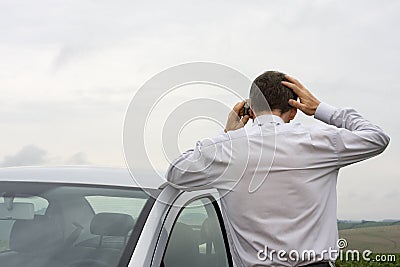 Worried businessman talking on cell phone Stock Photo