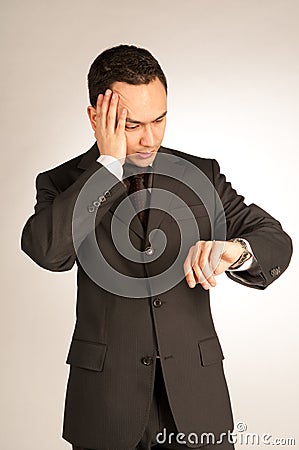 Worried businessman with watch Stock Photo