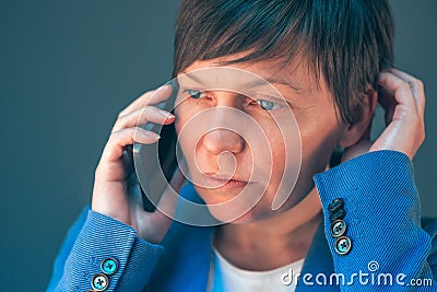 Worried businesswoman during unpleasant telephone conversation Stock Photo