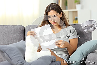 Worried disabled woman reading a letter Stock Photo