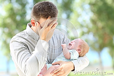 Worried father and baby crying Stock Photo