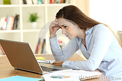 Worried freelance worker reading bad news on line Stock Photo