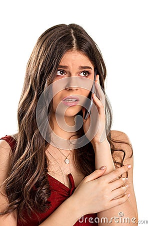 Worried girl holds cell phone. Stock Photo