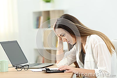 Worried housewife doing accounting Stock Photo