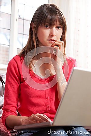 Worried Looking Woman Using Laptop Stock Photo