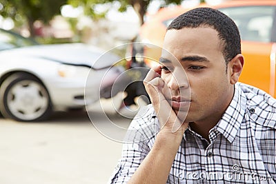 Worried Male Driver Sitting By Car After Traffic Accident Stock Photo