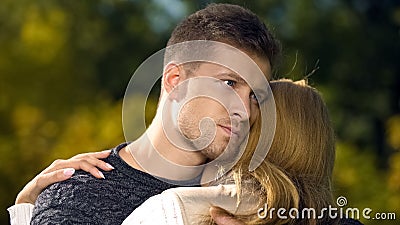 Worried man embracing woman, supporting after loss of close person, care Stock Photo