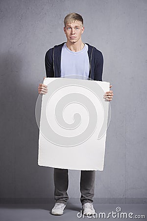 Worried man holding white empty panel. Stock Photo