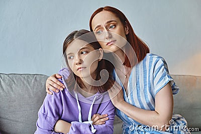 worried mother embracing and calming upset Stock Photo